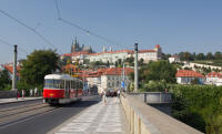 Tram on Mánesův most (bridge) with Prague Castle in background