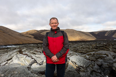 Tourist and lava field in the Geldingadalur valley