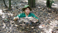 A guide demonstrates a hiding place