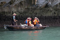 Tourists being (upright) rowed around an island