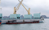Loading rock from small ship to large