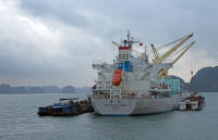 Loading rock from small ship to large