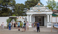 Donopratono gate and a Dwarapala guardian statue, at the Kraton, Yogyakarta, with visitors