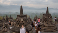 Perforated stupas, misty jungle, hills