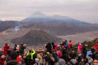 Mount Bromo and Mount Batok, with Mount Semeru in the background, and onlookers