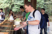 Tourist purifying at shrine: right hand