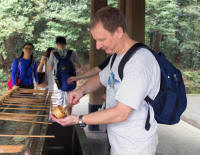 Tourist purifying at shrine: water for cleaning mouth