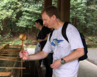 Tourist purifying at shrine: cleaning ladle