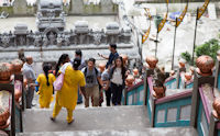 Visitors and monkey on the steps leading up to the Temple Cave