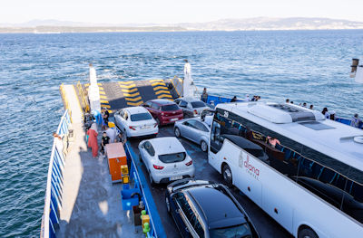 Vehicles, including the tour bus and driver Amir, on the ferry